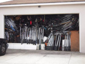 Cluttered garage with golf clubs gathering dust