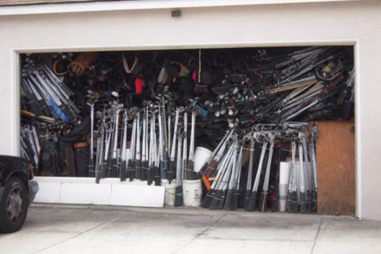 Cluttered garage with golf clubs gathering dust